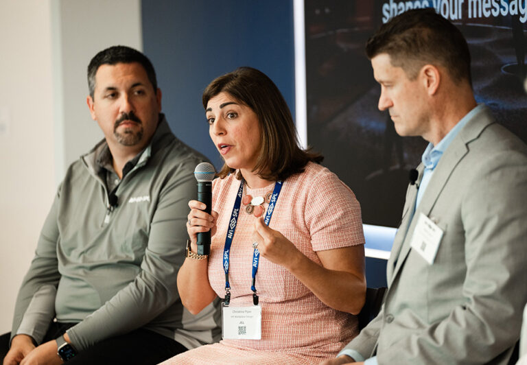 Three VIBE panel speakers addressing the audience